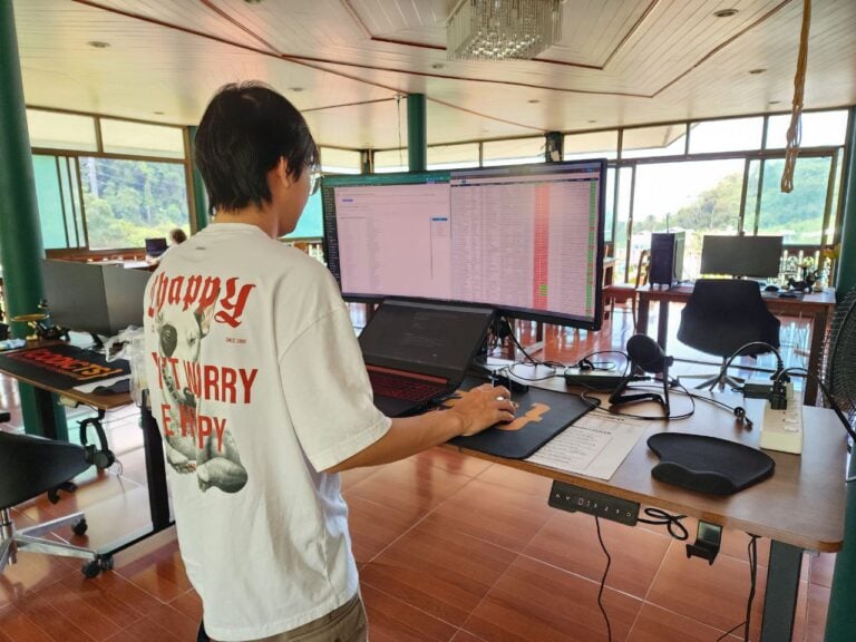 Coworking Phuket: Denz CoWorking Cafe, mountain view, standing desks, Patong Bay in background. Alt text: "Coworking cafe in Phuket with mountain views over Patong Bay at Denz CoWorking